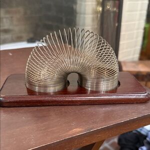 Metal Slinky on Wooden Base